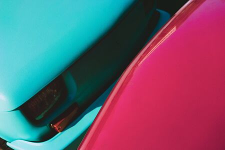 Three cars of different colors are in a row behind each other on the roadの写真素材