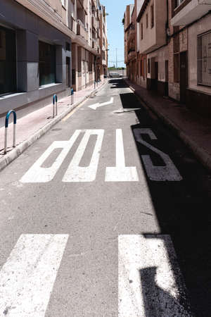 Urban modern cityscape in the southern city of Spain. Sun and shadows from buildings. Sick information inscriptions on the asphalt. Mediterranean Sea. Spainの写真素材