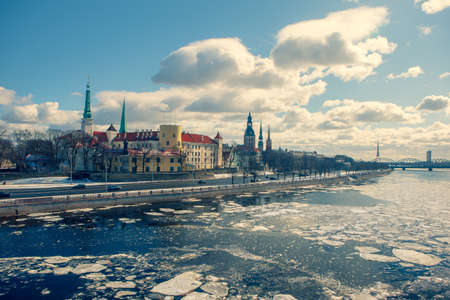 Riga panorama in spring with ice drift on the Daugava. Panorama of Riga in spring with ice drift on the Daugava. On a sunny day, the presidential palace and churches with cockerels on spiers are very beautiful.の写真素材