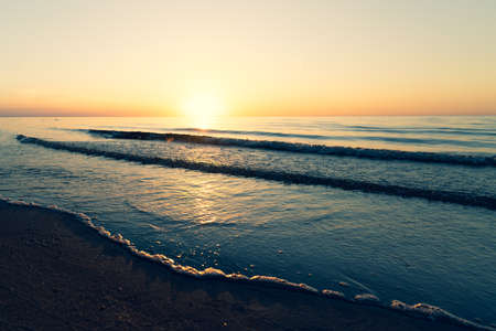 Baltic Sea skyline with clear sky and small wave at sunset in summer. Latviaの写真素材