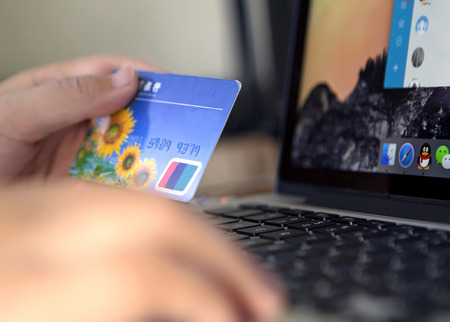 Man doing online shopping with credit card on laptopのeditorial素材