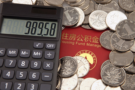 A lot of coins and calculator on the background of housing accumulation fund bankbookのeditorial素材