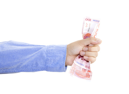 Hand squeezing bunch of moneyの写真素材