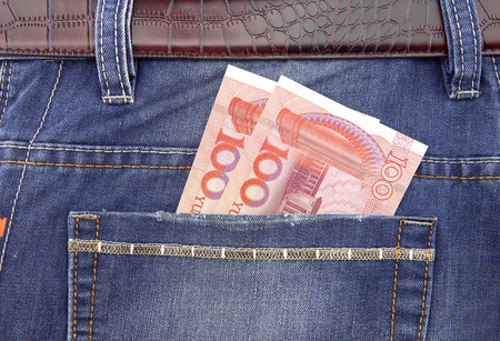 One hundred yuan bills in the pocketの写真素材