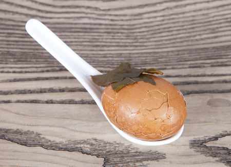 A tea egg placed in a spoon