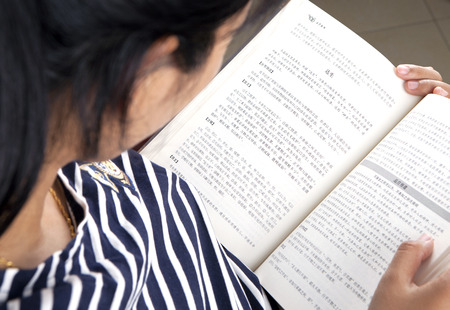Top view of a woman reading a chinese bookのeditorial素材