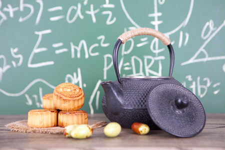 A teapot and moon cakes on the wooden tableの写真素材