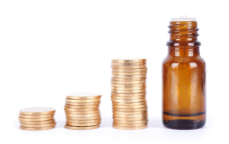 Dollar coins and bottles of Medicineの写真素材