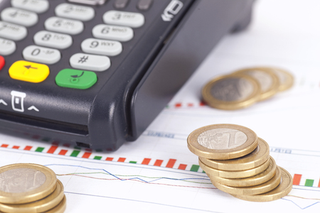 Card terminal and scattered dollar coinsの写真素材