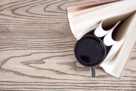 book and coffee on wooden deskの写真素材