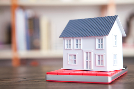 A house model on a calculatorの写真素材