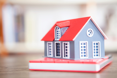 A house model on a calculatorの写真素材
