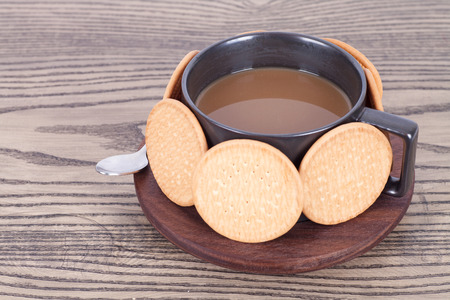 Hot coffee surrounded by biscuitsの写真素材