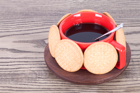 Hot coffee surrounded by biscuitsの写真素材