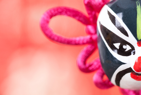 A Chinese knot with peking opera maskの写真素材
