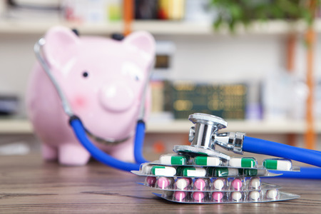 A piggy bank with a stethoscopeの写真素材