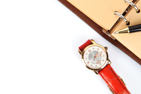 Notebook and watch on white backgroundの写真素材