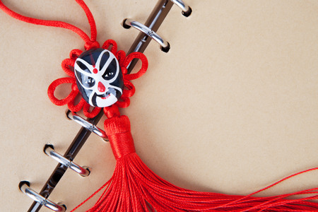 Chinese traditional knot on a brown notebook pageの写真素材