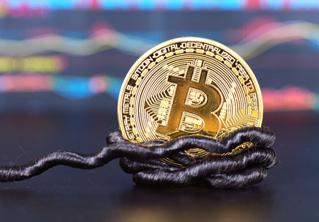 A bit of bitcoin tied to a ropeの写真素材