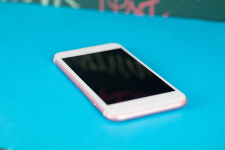 Mobile phone on blue backgroundの写真素材