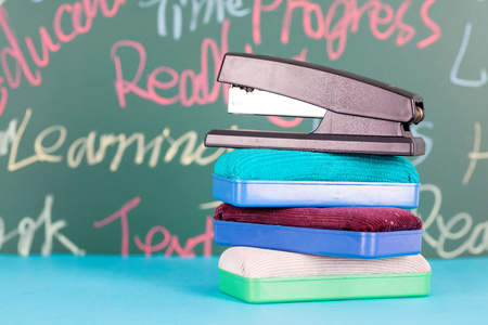Board eraser and stapler in front of the blackboardの写真素材