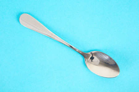 Spoon on blue backgroundの写真素材