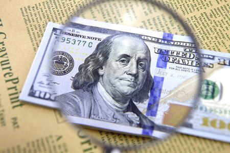 Use a magnifying glass to observe US dollars