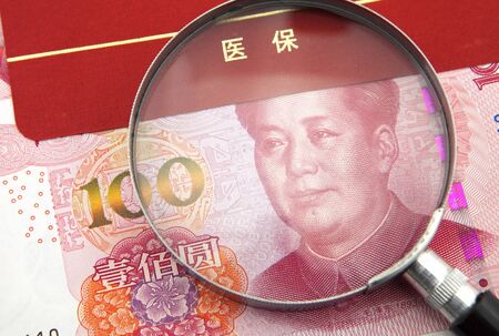 Medical insurance concept, RMB with magnifierの写真素材