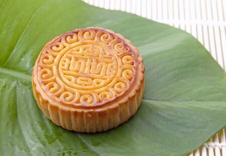 Moon cake on green leaf, refreshments of mid autumn festival