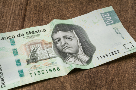A 200 mexican pesos bill seems to be sad perhaps because of its weakness against the dollar.の写真素材