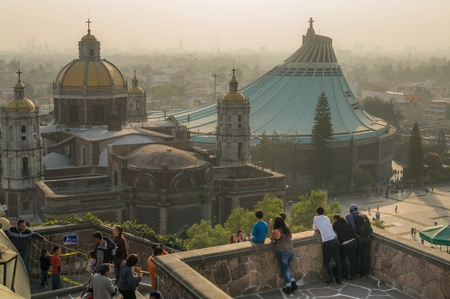 VILLA OF GUADALUPE, MEXICO CITY, DECEMBER 02, 2017 - Visitors enjoy a panoramic view of the Old and New Basilica of Guadalupe from a balcony of the Church of the Hill.のeditorial素材