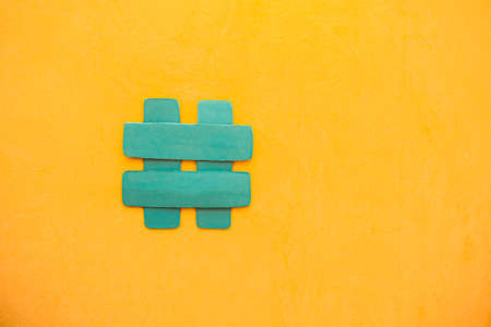 Hashtag symbol, number, cat on yellow background. copy space