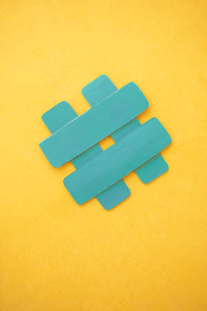 Upright image. Hashtag symbol, number, cat on yellow backgroundの写真素材