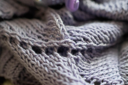 Knitted cardigan or jacket. A cozy composition in a homely atmosphere. The texture of cotton yarn .Comfortable stylish fabric. Material with wavy folds. soft focusの写真素材