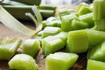 juicy green slices of chopped young stalk of rhubarb on the table selective focusの写真素材