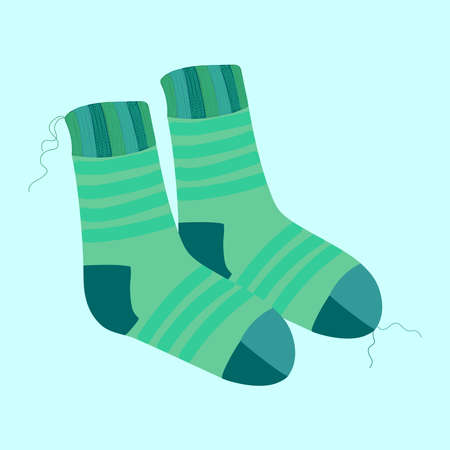 a pair of knitted warm striped turquoise socks with protruding threads on a blue background