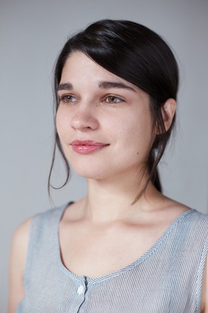 portrait of a young cute girl, natural and laid-back, brunette looks asideの写真素材
