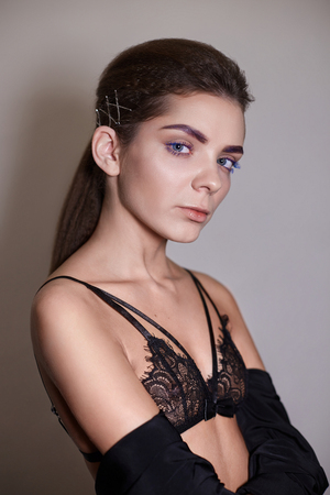 close-up face of young tender girl brunette with blue eyelashesの写真素材