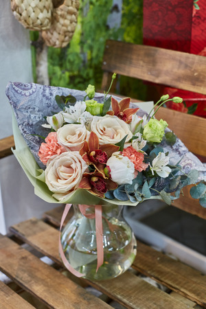 a bouquet of roses, orchids, eucalyptus, eustoma. Brown and green flowers.の写真素材