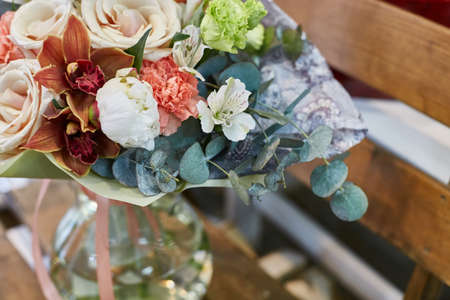 a bouquet of roses, orchids, eucalyptus, eustoma. Brown and green flowers.の写真素材
