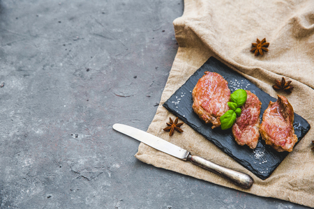 Grilled meat over dark background with copy spaceの写真素材