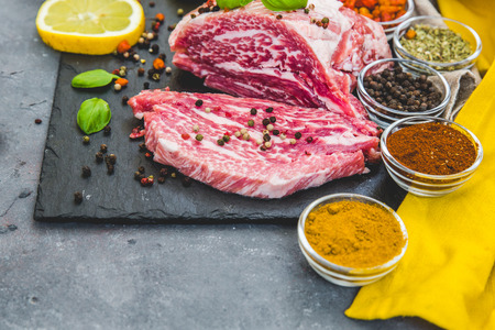 Fresh meat with spices over dark backgroundの写真素材