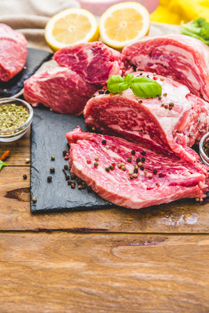 Fresh meat with spices over wooden backgroundの写真素材