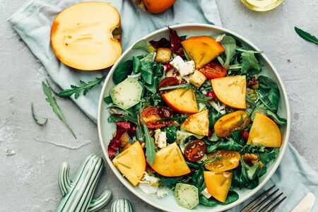 Fresh autumn salad with persimmon, arugula, cheeseの写真素材