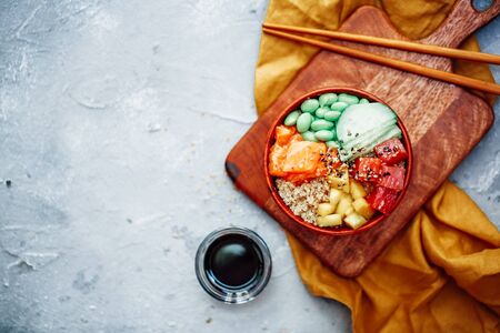 Raw Organic Ahi Tuna Poke Bowl with Rice and Veggies close-up on the tableの写真素材