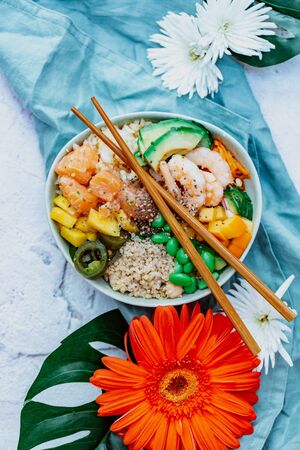 An overhead photo of poke, traditional Hawaiian raw fish salad, with chopsticks and copy spaceの写真素材