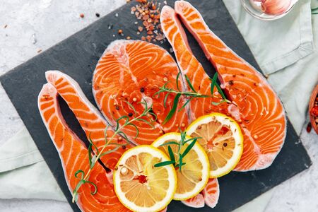 Raw red salmon steaks on a back board. Top view の写真素材