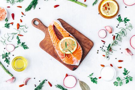 Fresh salmon fillet with aromatic herbs and spices- healthy food, diet or cooking concept.の写真素材