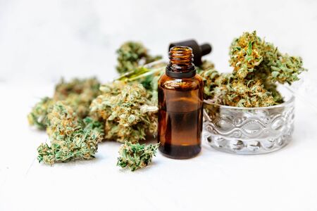 Cannabidiol oil in bottles with droppers on white surface , Medical Cannabis ( Marijuana ) oil ready for consumptionの写真素材