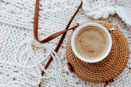 Rattan bamboo bag and cup coffee on white blanket background. の写真素材